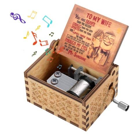 A charming vintage hand-crank music box, engraved with love, perfect for your wife on special occasions.