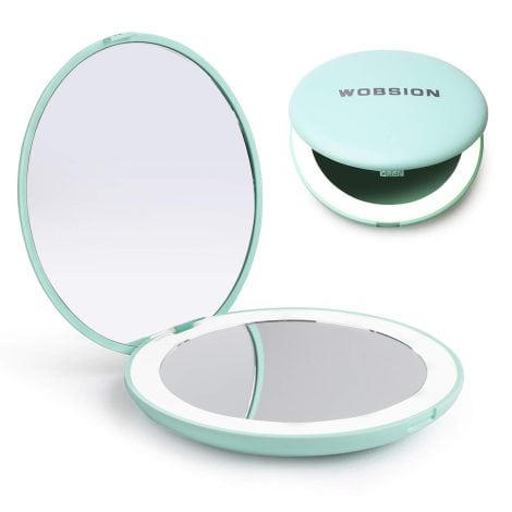 Travel-friendly, illuminated makeup mirror with 1x/10x magnification. Perfect for on-the-go touch-ups. Compact and portable.