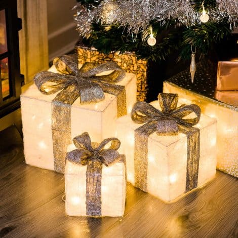 Set of 3 LED Christmas gift boxes with sparkly finish, decorative bow, and illumination. Perfect for decorating.